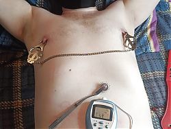BDSM electro stimulation of dick in chastity belt, play with nipples.